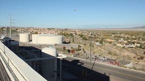 Rooftop view from CUB of 2, 1-million gallon water tanks, 250,000 gallon fire system water tank, oil-free air tank, emergency generator exhaust stack, the Village of Corrales and North Valley.